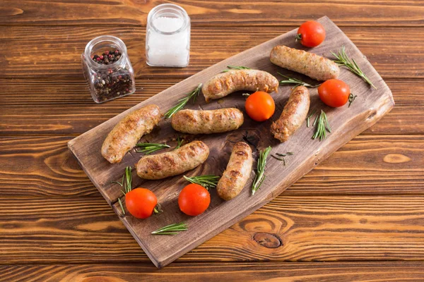 Grilled sausages with tomatoes , pepper and rosemary — Stock Photo, Image