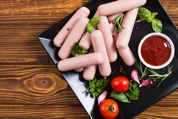 Raw beef sausages with pepper , herbs and ketchup — Stock Photo, Image