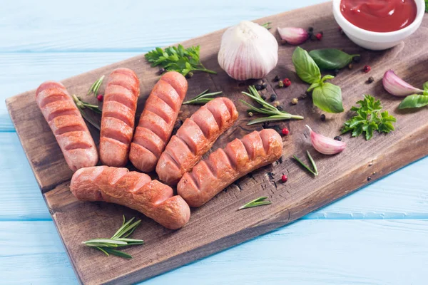 Fried sausages with herbs , spices and ketchup — Stock Photo, Image