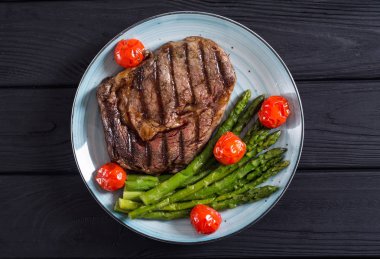 Kiraz domates ve kuşkonmaz ile ızgara sığır biftek ribeye