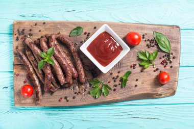 Domates, biberiye ve biberiye ile ızgara sosis