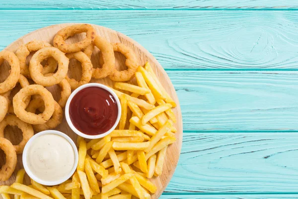 French fries and onion rings with sauces — Stock Photo, Image