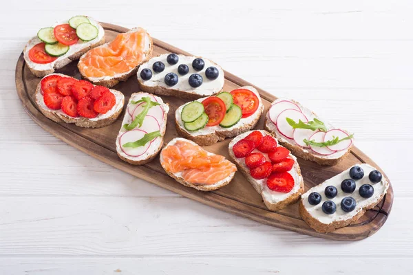 Variation of toast with fruit , vegetable and salmon — Stock Photo, Image