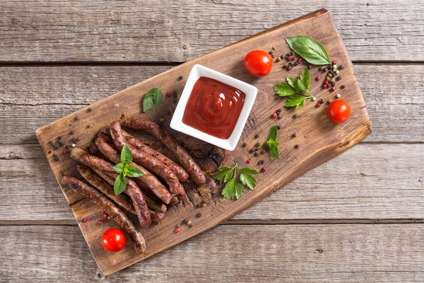 Grilled sausages with tomatoes , pepper and rosemary — Stock Photo, Image