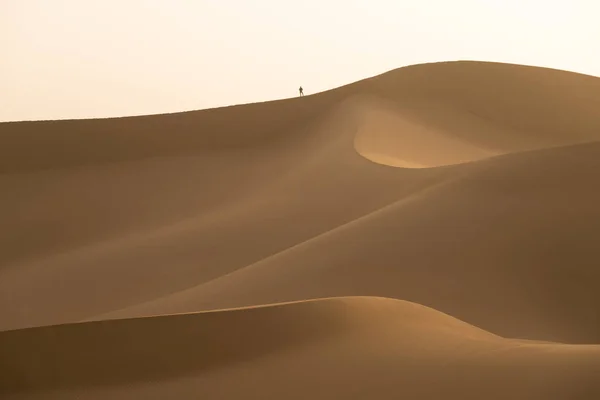 Montañas de arena y silueta de hombre pequeño — Foto de Stock