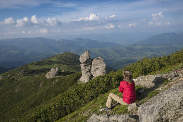 Woman contemplates mountains