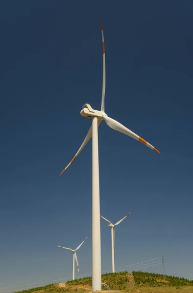 Wind power station against blue sky background