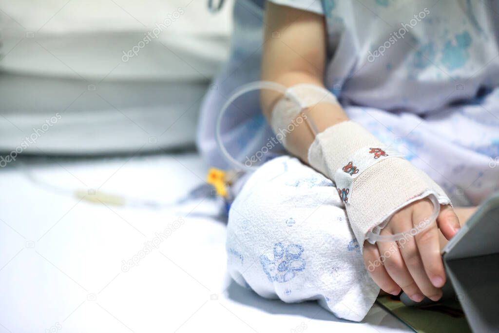 Sick child on a receiving a saline solution in hospital