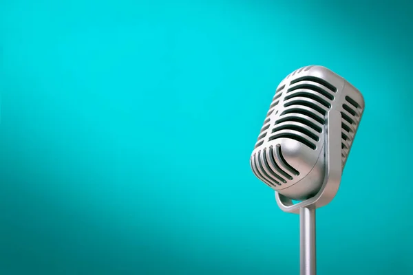 Retro style microphone on green wall background with light comes to the left