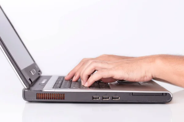 Hand man typing writing on laptop keyboard on white background