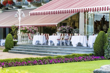 Luxury Italian Restaurant in a Blooming Garden  clipart