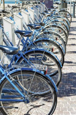 COMO,ITALY - JUNE 27,2018 : Bike Sharing Service Racks.Modern Concept of Ecological Transportation, Bike Urban Transport clipart