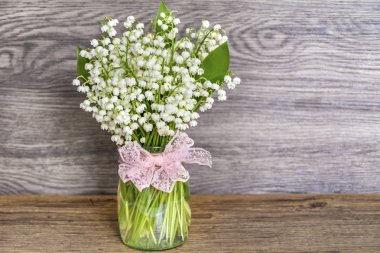 Lily vadi buket cam vazo içinde sunulan. Bahar çiçekleri arka plan