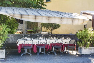 Italian Outdoor Restaurant with White Umbrellas in Italy 