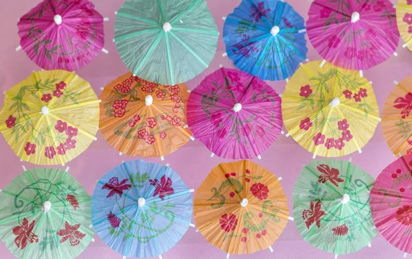 Decorative Cocktail Umbrellas on a Pink Background