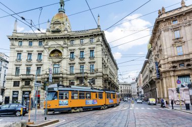 MILAN,ITALY -JUNE 27,2018 :Historic Tram on the Street in Milan,Italy .Street Traffic with Yellow Trolley Car