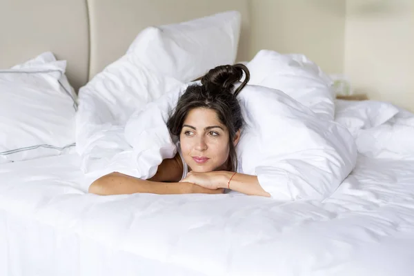 Caucasian young woman in bed at home