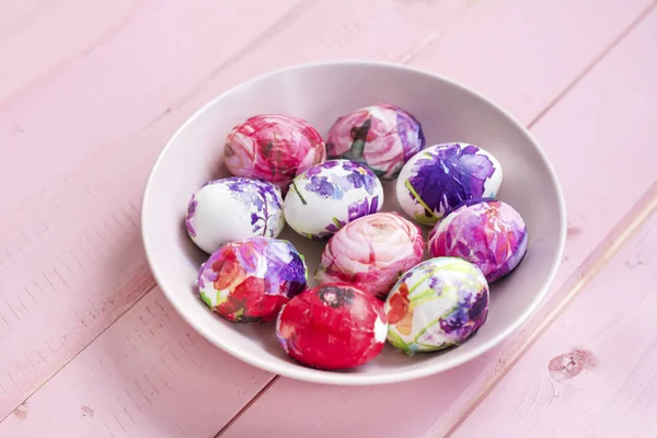 Easter Eggs in a Pink Bowl  on a Pink Wooden Background