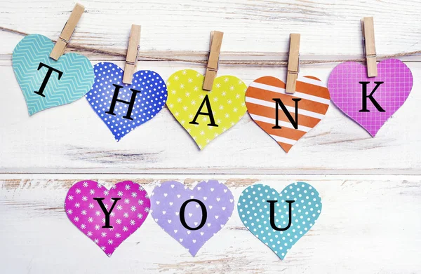 Paper Hearts with Thank you text on a White Wooden Planks Background