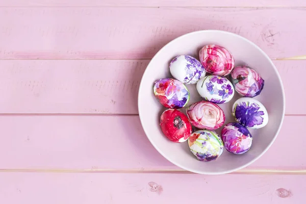 Easter Eggs in a Pink Bowl  on a Pink Wooden Background