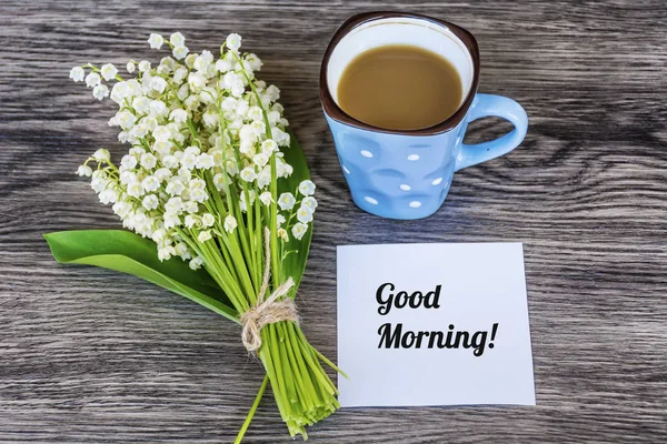 Bouquet of Lily of the Valley and Cup of Coffee for  Good Morning .Spring Morning Concept