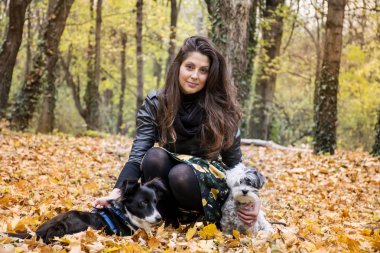 Young beautiful woman with two dogs in park