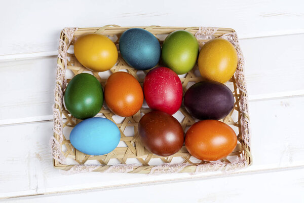 Easter eggs in the basket  on  wooden background