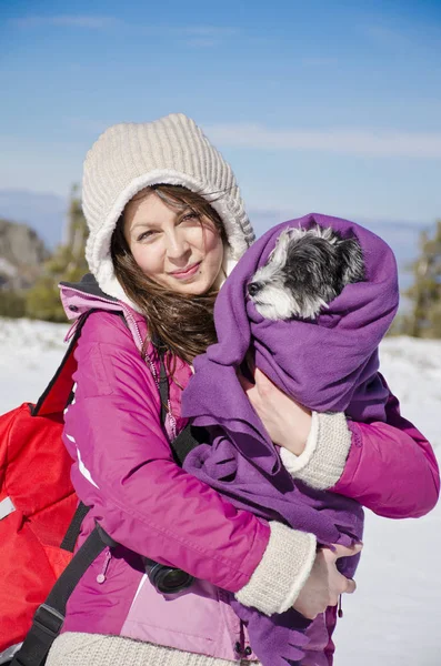 Beautiful Woman Hugging  Her Cute Dog in the Winter Forest.Pet and Owner Outdoor
