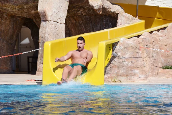 Boy Having Fun on  a Water Slide .Water Tester