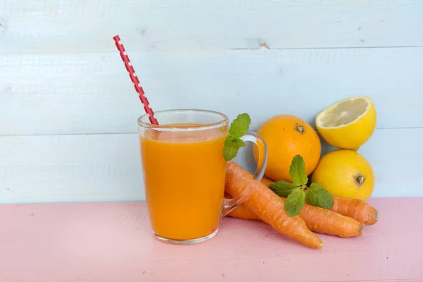 orange smoothie juice with carrots lemon and orange . Healthy life concept.
