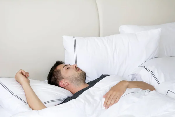 Sleeping young man in bedroom