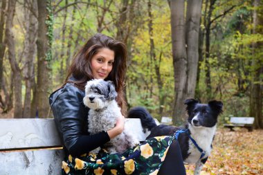 Young beautiful woman with two dogs in park