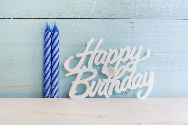 Happy Birthday Candles isolated on a blue  Wooden Background