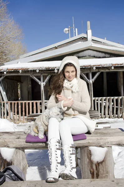 Beautiful woman with her little dog on nature background