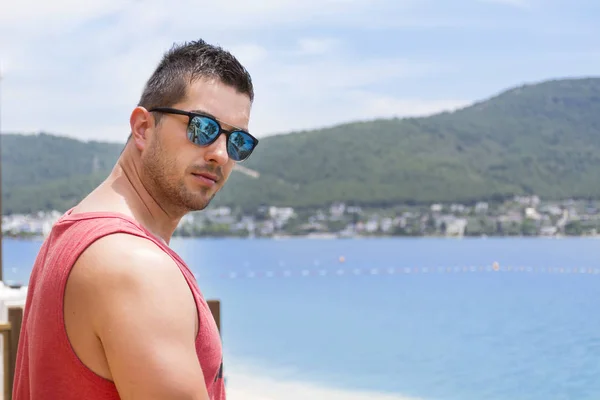 handsome young man looking the sea