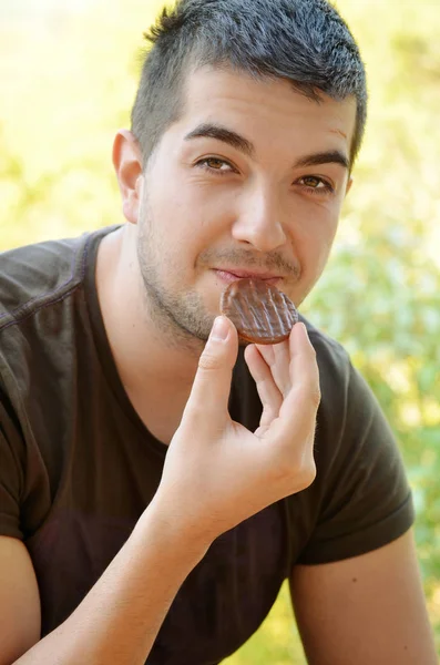 Portrait of man eating cookie