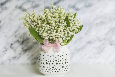Lily vadi buket mermer Background.Spring çiçek arka plan üzerinde pembe kurdele ile vazoda