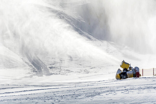 Professional Artificial Snow Machine Making Snowflakes at Ski Slope in Ski Resort Bansko in Bulgaria .Snowmaking Cannon