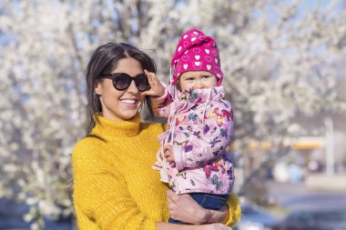 Güzel parkta küçük çocuğunu elleri tutan anne 