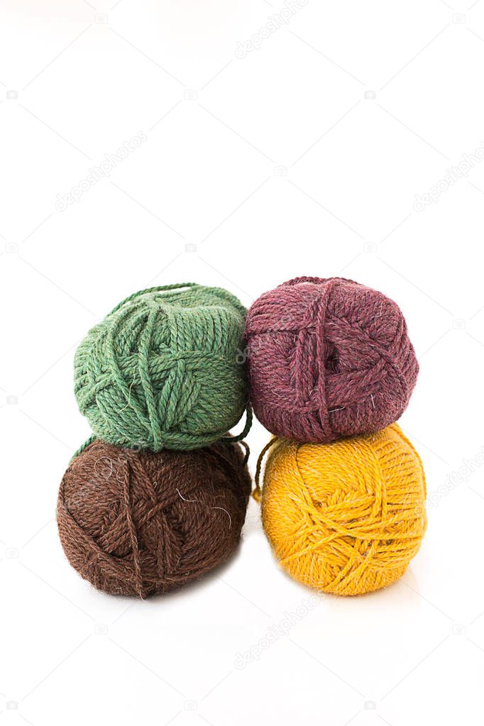 skeins, bolls,  for knitting  crocheted crocheted soft colored wool on white background