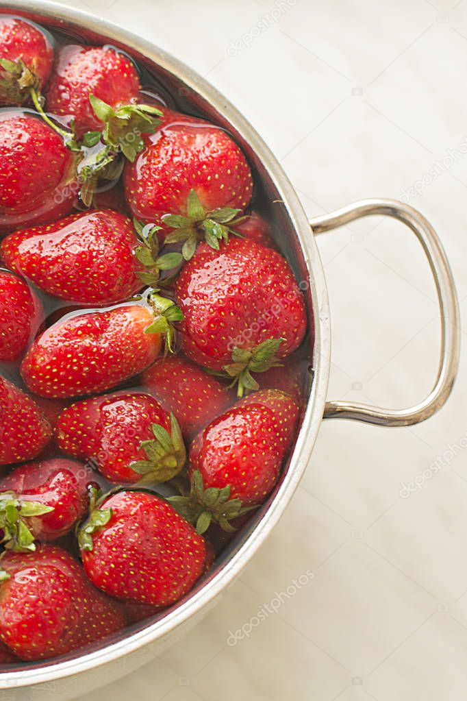 strawberry fragrant fresh summer clean in a saucepan with water