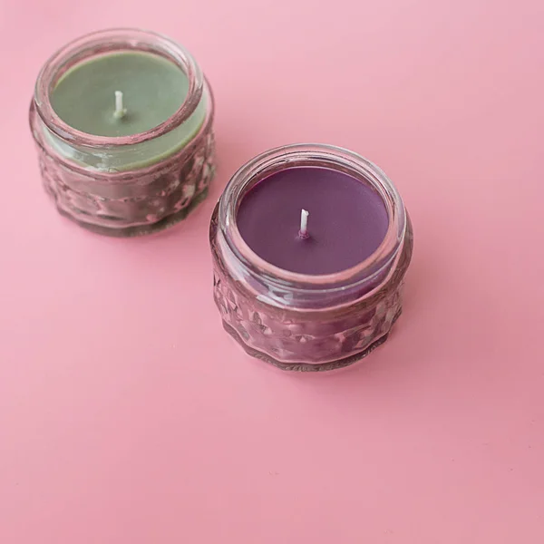 fragrant candles on a pink square background