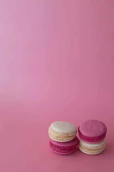 Quattro maccheroni dolci francesi su fondo rosa — Foto Stock