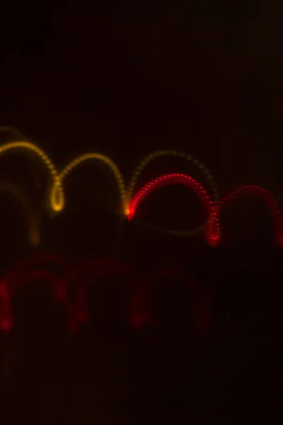 Lights blurred neon waves bokeh on dark background — Stock Photo, Image
