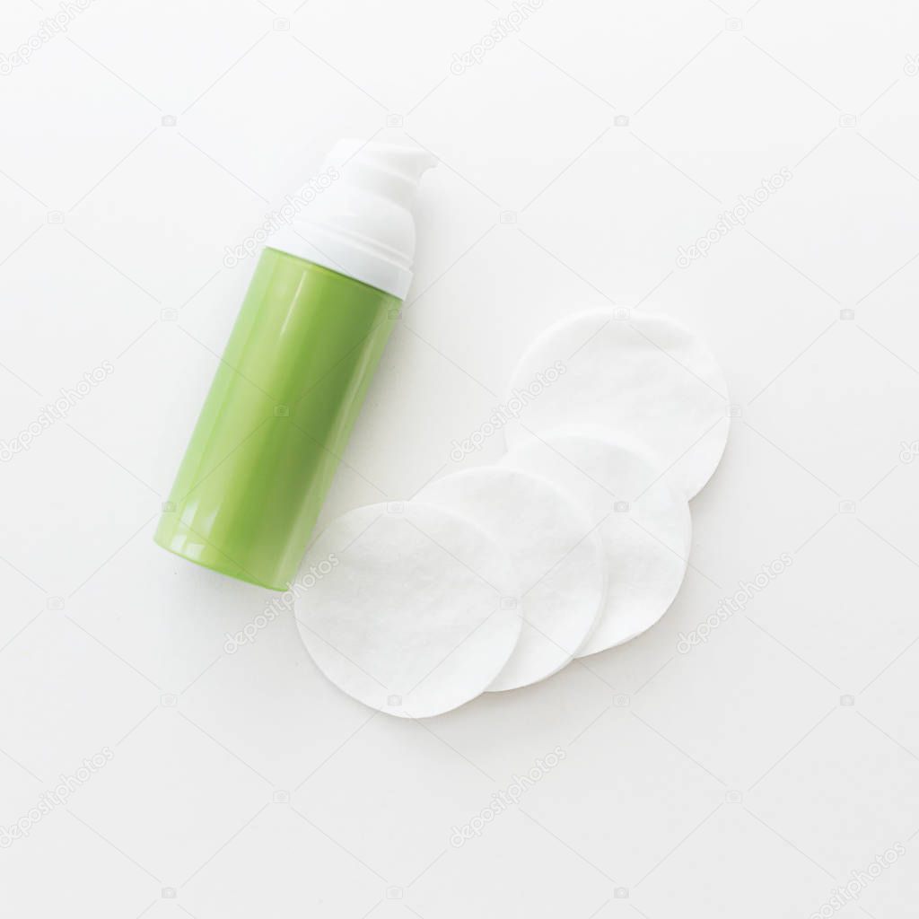 cream for face and body on a light square background