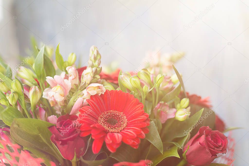 Floral arrangement with red gerbera and different fresh flowers