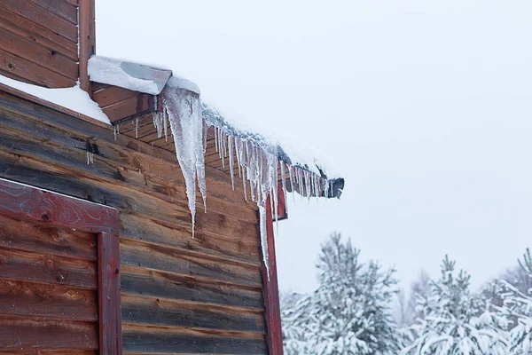 Зимняя композиция. Сосульки и снег на крыше . — стоковое фото