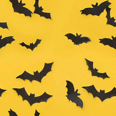 Cadılar Bayramı süslemeleri. Kusursuz desen. Sarı arka planda yarasalar. Model ve projenin konsepti. F