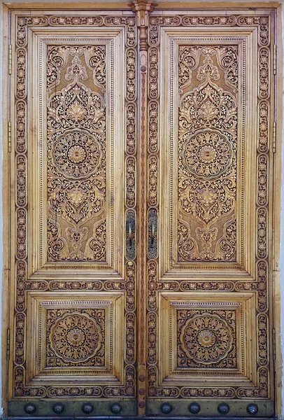 ANCIENT WOODEN DOOR WITH ORNAMENT. MANUAL WORK, THREAD THROUGH THE TREE. EASTERN, ARABIAN. eastern wooden door with ornament. Islamic ornament