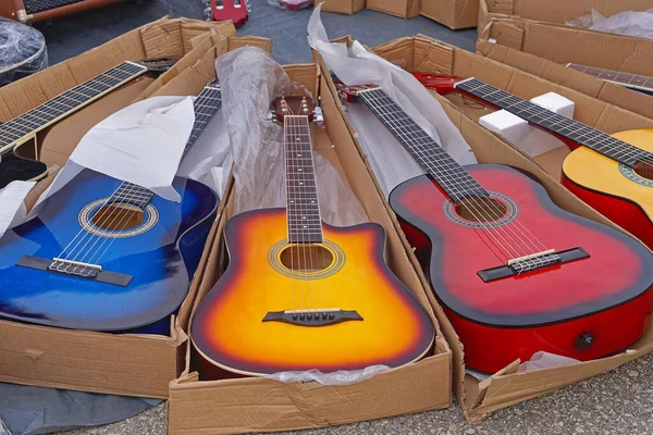 Many new colourful guitars music instruments for sale